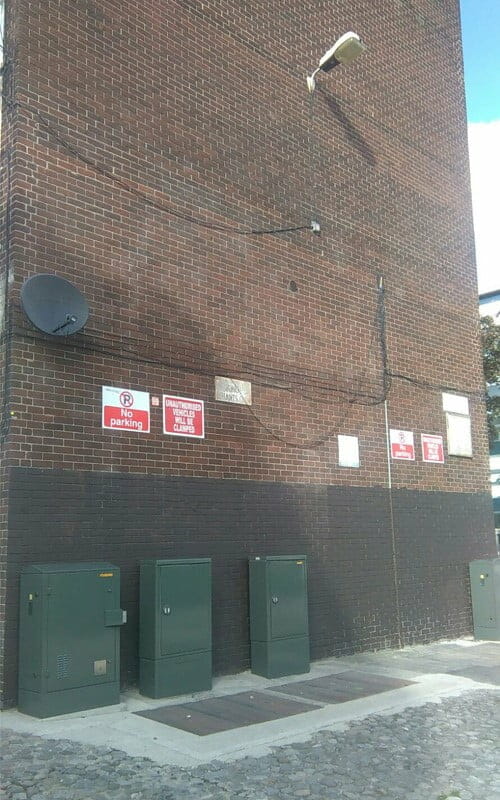 Graffiti removed from the red brick wall at Tom Kelly Road flats