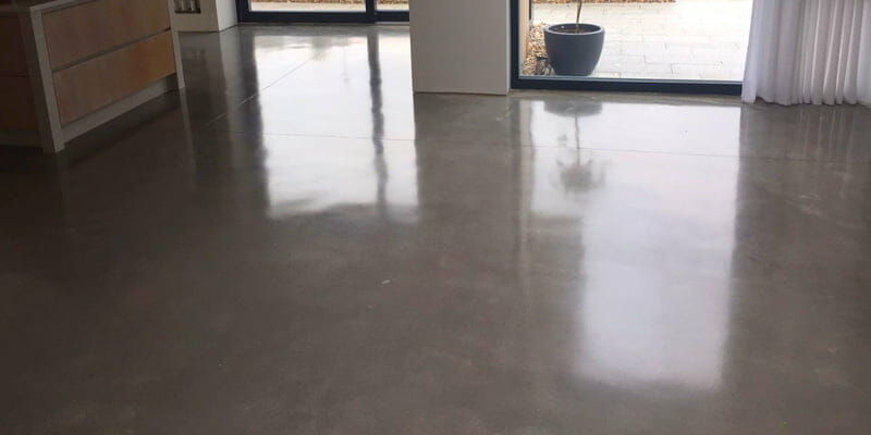 Polished concrete to gold finish coated with a topical seal