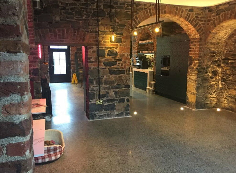 Stone-and-brick-walls-cleaned-and-restored.-Concrete–floor-polished-by-PMac Restoration of 19th century brick and limes stone walls by PMAC