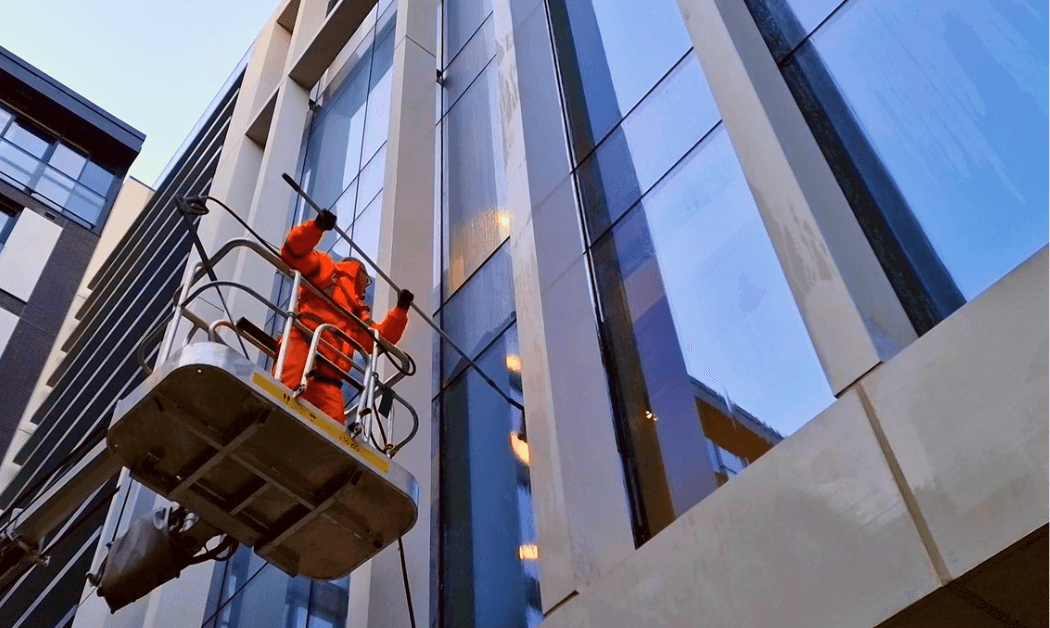 Operative on hoist cleaning minerals from Glazing