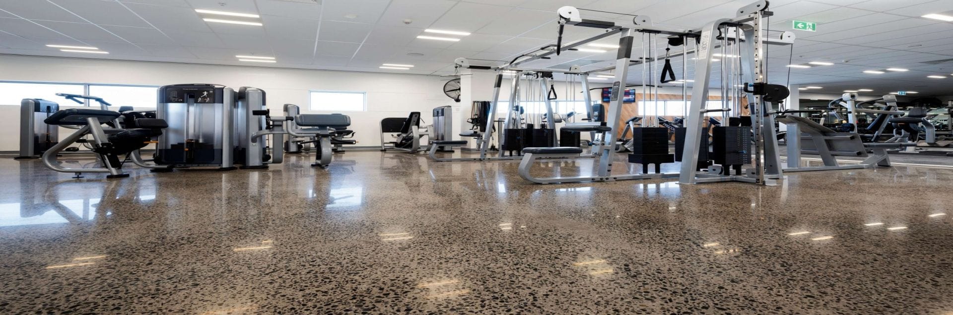 Choice-1-resized-Commercial-Polished-Concrete-Header-scaled Polished concrete in gym surrounded by weight lifting equipment