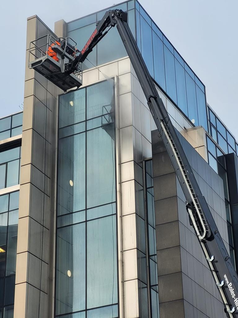 PMAC operatives cleaning Office building from a MEWP PMAC operatives cleaning Office building from a MEWP