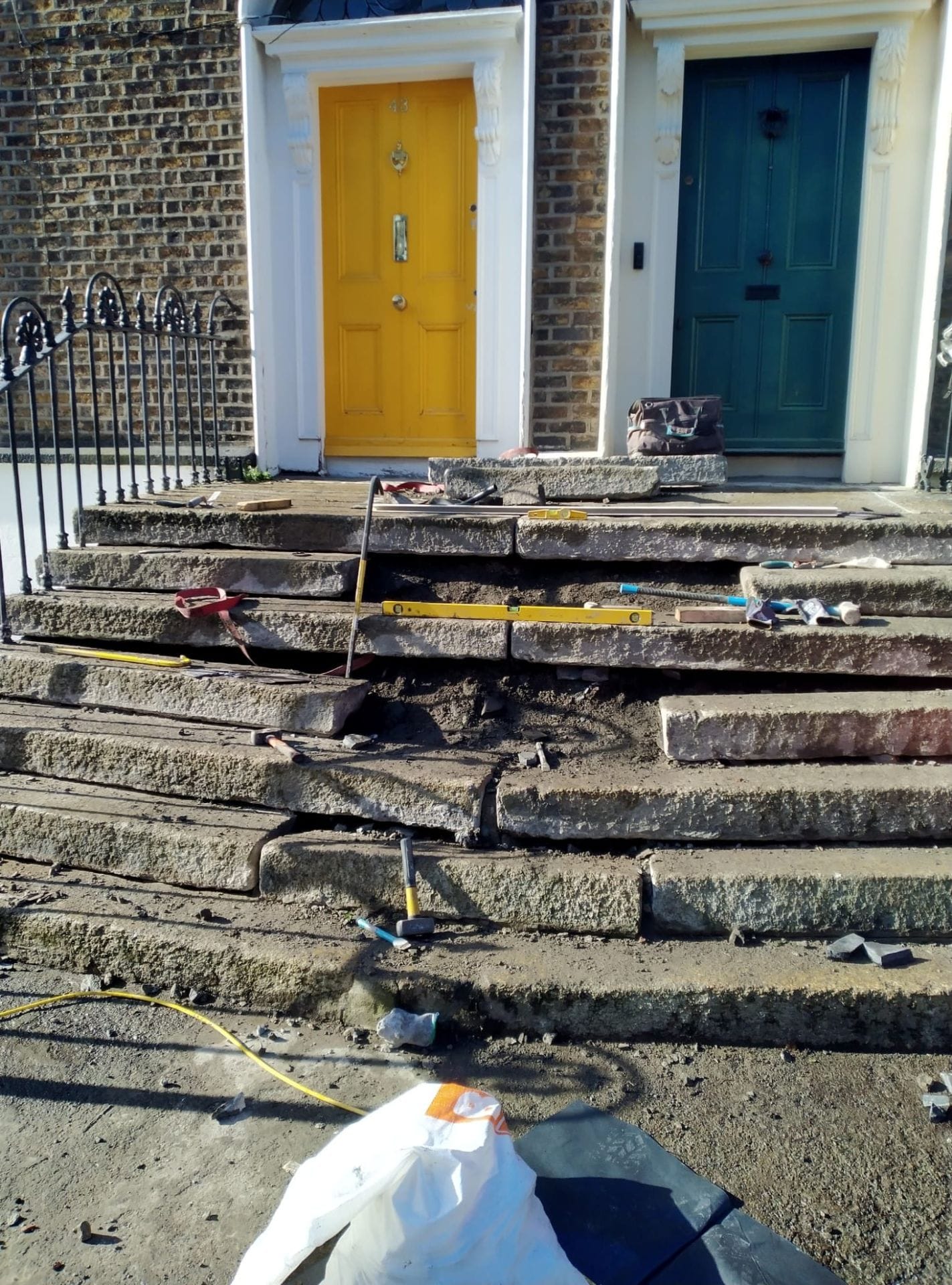 Untitled design Front view of granite steps showing some stones removed so they can be made level